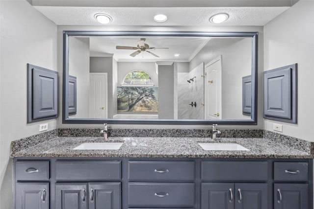 4206 Misty Timbers Way, Houston, TX 77345 - bathroom featuring double vanity, ceiling fan, tiled shower, ornamental molding, and a textured ceiling
