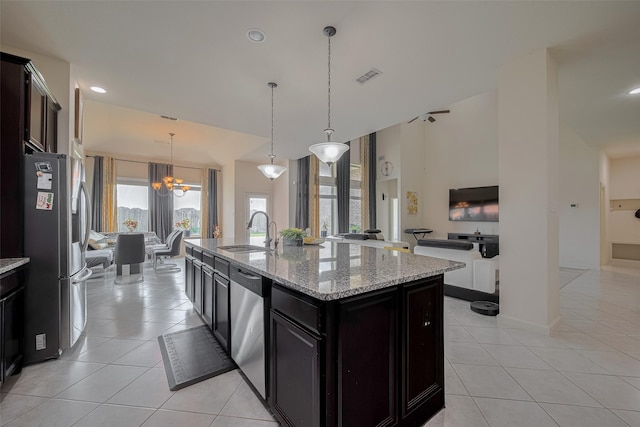 27003 Lindenwood Creek Ln, Katy, TX 77494 - kitchen with a sink, appliances with stainless steel finishes, a chandelier, light tile patterned flooring, and light stone countertops
