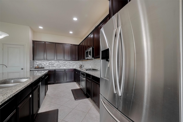 27003 Lindenwood Creek Ln, Katy, TX 77494 - kitchen with stainless steel appliances, a sink, tasteful backsplash, light tile patterned floors, and light stone countertops