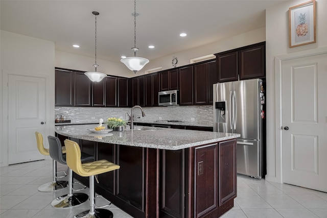 27003 Lindenwood Creek Ln, Katy, TX 77494 - kitchen with appliances with stainless steel finishes, a sink, light tile patterned floors, decorative backsplash, and recessed lighting