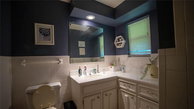 205 Mesa Dr, Gatesville, TX 76528 - bathroom with toilet, vanity, tile walls, and a wainscoted wall