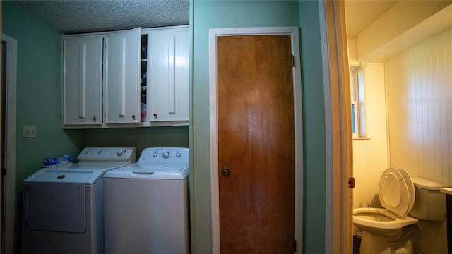 205 Mesa Dr, Gatesville, TX 76528 - washroom featuring cabinet space, washer and dryer, and a textured ceiling