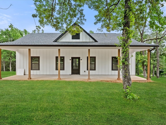 71 Prescott Dr, New Waverly, TX 77358 - view of front facade with roof with shingles, board and batten siding, a front lawn, and a porch