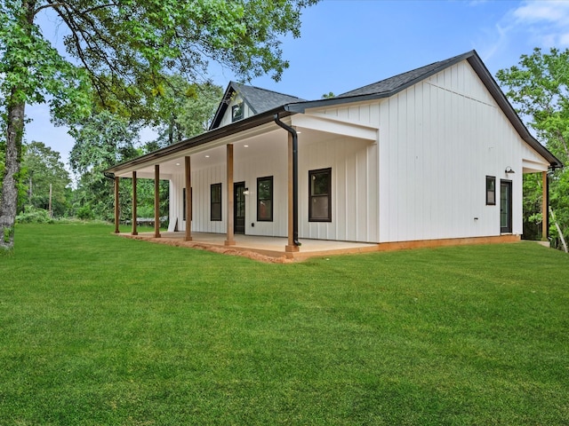 71 Prescott Dr, New Waverly, TX 77358 - back of property with a patio area, a yard, and board and batten siding