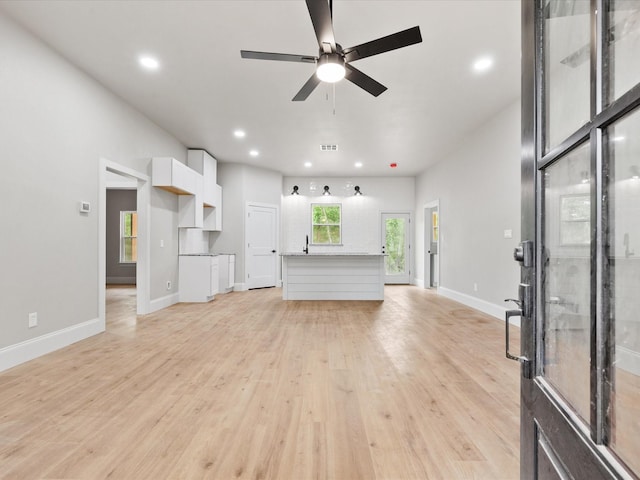 71 Prescott Dr, New Waverly, TX 77358 - unfurnished living room with ceiling fan, recessed lighting, light wood finished floors, and baseboards
