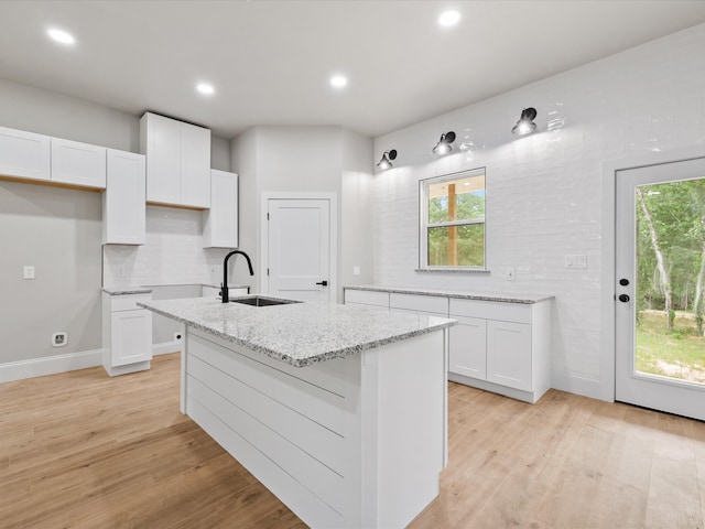 71 Prescott Dr, New Waverly, TX 77358 - kitchen featuring light wood-type flooring, white cabinetry, plenty of natural light, and recessed lighting