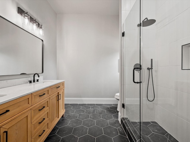 71 Prescott Dr, New Waverly, TX 77358 - bathroom featuring double vanity, tiled shower, toilet, tile patterned floors, and baseboards