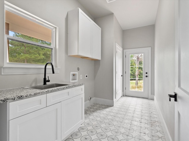 71 Prescott Dr, New Waverly, TX 77358 - laundry room with hookup for an electric dryer, baseboards, cabinet space, washer hookup, and light flooring