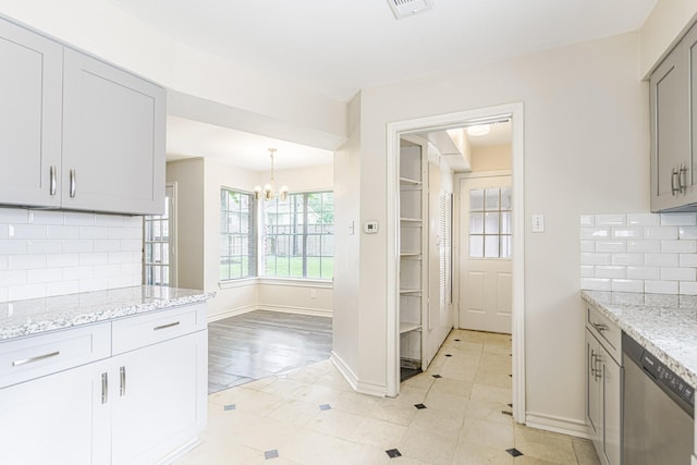 5247 Ariel St, Houston, TX 77096 - kitchen with dishwasher, a chandelier, gray cabinets, tasteful backsplash, and light stone countertops