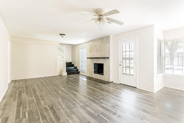 5247 Ariel St, Houston, TX 77096 - unfurnished living room featuring stairs, light wood-style floors, plenty of natural light, and a ceiling fan