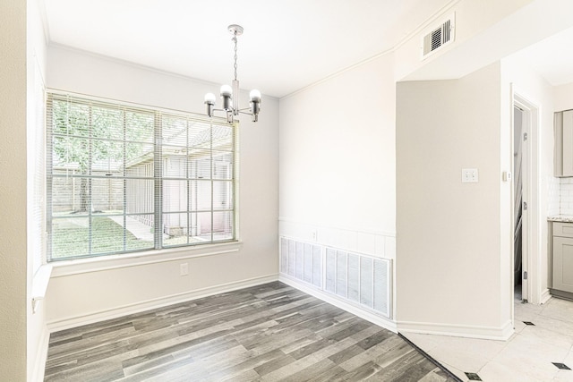 5247 Ariel St, Houston, TX 77096 - empty room with a chandelier, plenty of natural light, light wood finished floors, and baseboards
