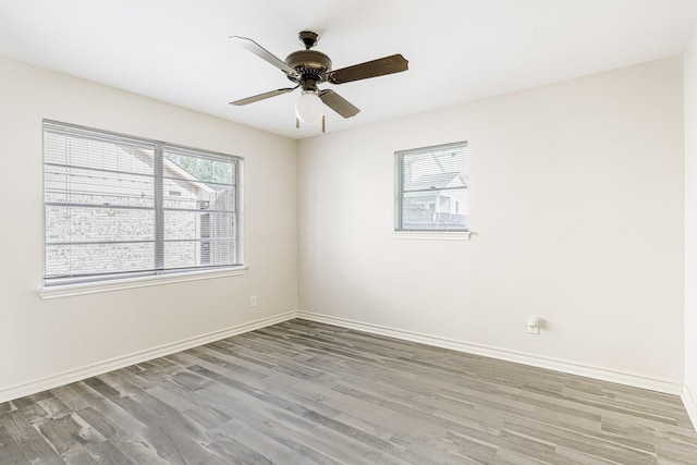 5247 Ariel St, Houston, TX 77096 - spare room with wood finished floors, baseboards, and ceiling fan