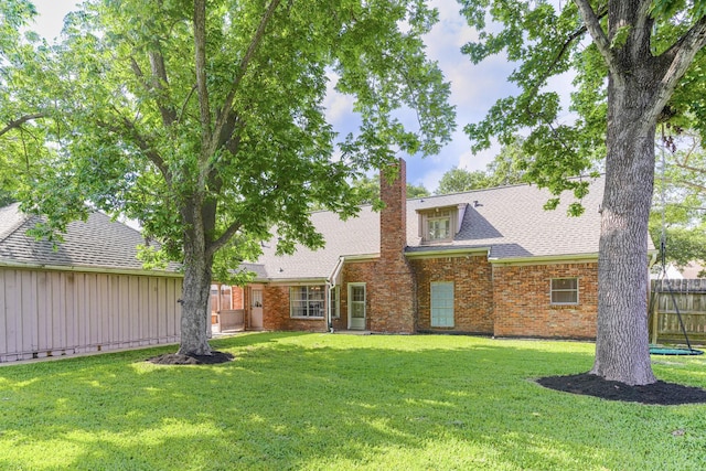 5247 Ariel St, Houston, TX 77096 - back of house featuring a chimney, brick siding, and roof with shingles