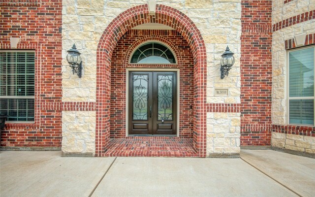 26510 Crimson Bluff Ln, Katy, TX 77494 - entrance to property featuring french doors, brick siding, and stone siding