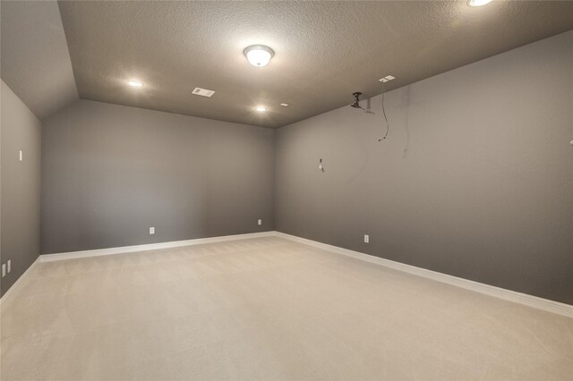 26510 Crimson Bluff Ln, Katy, TX 77494 - spare room with light carpet, a textured ceiling, baseboards, recessed lighting, and vaulted ceiling