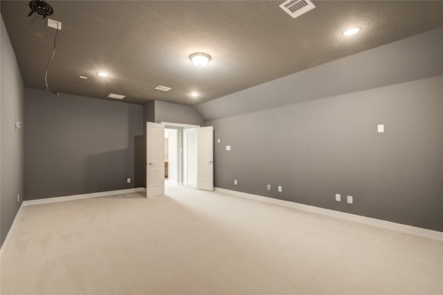 26510 Crimson Bluff Ln, Katy, TX 77494 - unfurnished room with light colored carpet, baseboards, lofted ceiling, a textured ceiling, and recessed lighting