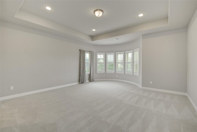 26510 Crimson Bluff Ln, Katy, TX 77494 - unfurnished room featuring a tray ceiling, light carpet, recessed lighting, and baseboards
