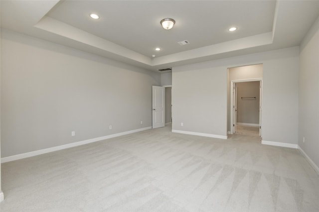 26510 Crimson Bluff Ln, Katy, TX 77494 - unfurnished bedroom with a tray ceiling, recessed lighting, baseboards, light colored carpet, and a spacious closet