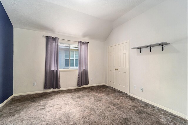 18530 S Wimbledon Dr, Katy, TX 77449 - spare room featuring carpet flooring, lofted ceiling, and baseboards