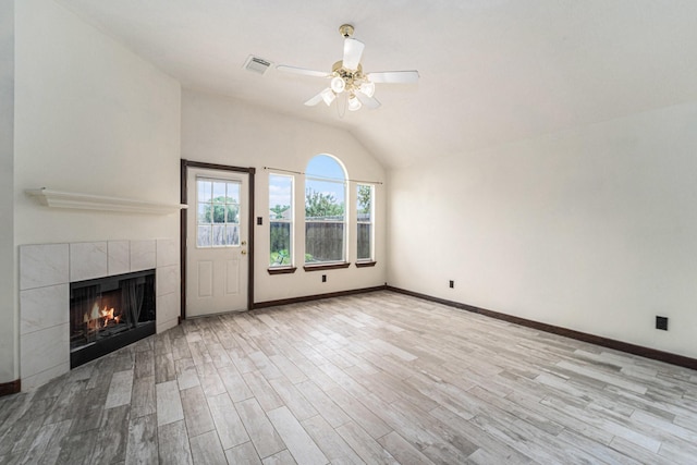 18530 S Wimbledon Dr, Katy, TX 77449 - unfurnished living room with lofted ceiling, a fireplace, ceiling fan, wood finished floors, and baseboards