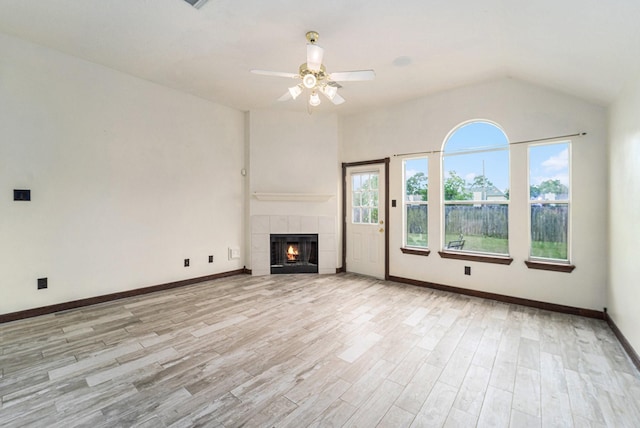 18530 S Wimbledon Dr, Katy, TX 77449 - unfurnished living room with light wood-style floors, ceiling fan, baseboards, and a tiled fireplace