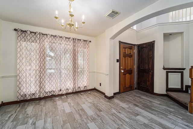 18530 S Wimbledon Dr, Katy, TX 77449 - entrance foyer with arched walkways, baseboards, and wood finished floors