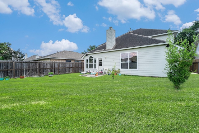 18530 S Wimbledon Dr, Katy, TX 77449 - rear view of property featuring a chimney, a patio, and roof with shingles