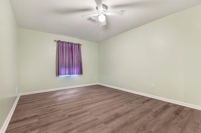 1037 Wall St, Houston, TX 77088 - empty room with a ceiling fan, wood finished floors, and baseboards