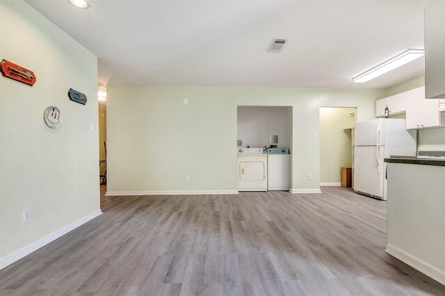 1037 Wall St, Houston, TX 77088 - unfurnished living room featuring separate washer and dryer, light wood-style flooring, baseboards, and recessed lighting