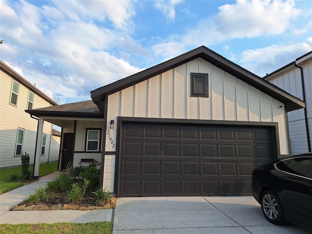 21402 Rising Fawn Rd, Porter, TX 77365 - view of front of home featuring board and batten siding, an attached garage, and concrete driveway