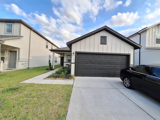 21402 Rising Fawn Rd, Porter, TX 77365 - view of front of home with board and batten siding, driveway, a front lawn, and a garage