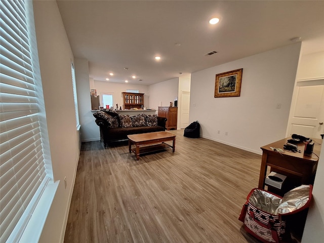21402 Rising Fawn Rd, Porter, TX 77365 - living room with wood finished floors, baseboards, and recessed lighting