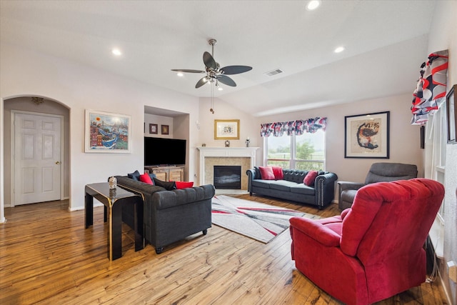 18719 Cypress Lake Village Dr, Cypress, TX 77429 - living room with ceiling fan, light wood finished floors, a glass covered fireplace, vaulted ceiling, and baseboards