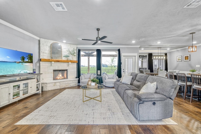 5315 Hammond Cir, Iola, TX 77861 - living area featuring ornamental molding, a fireplace, a ceiling fan, wood finished floors, and recessed lighting