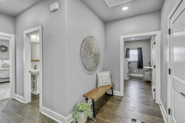 5315 Hammond Cir, Iola, TX 77861 - hall featuring wood finished floors, baseboards, recessed lighting, and independent washer and dryer