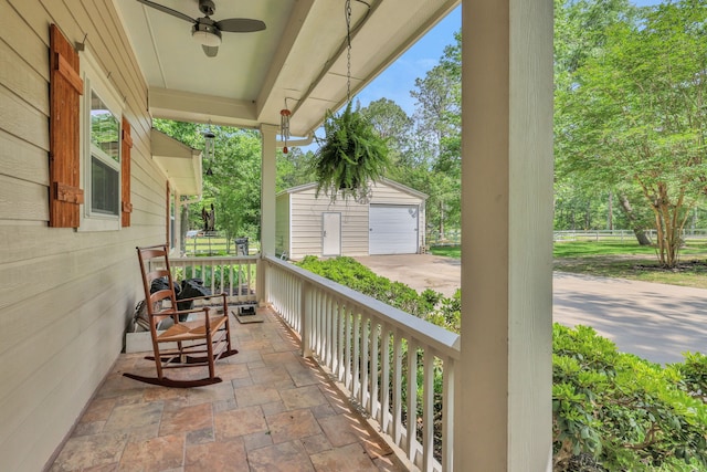 24240 Oak Hollow Blvd, Hockley, TX 77447 - covered porch featuring a garage, an outdoor structure, ceiling fan, and concrete driveway