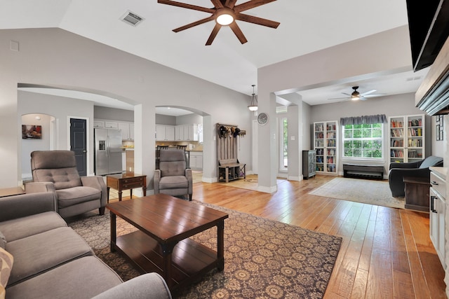 24240 Oak Hollow Blvd, Hockley, TX 77447 - living area featuring ceiling fan, arched walkways, lofted ceiling, light wood-style floors, and baseboards