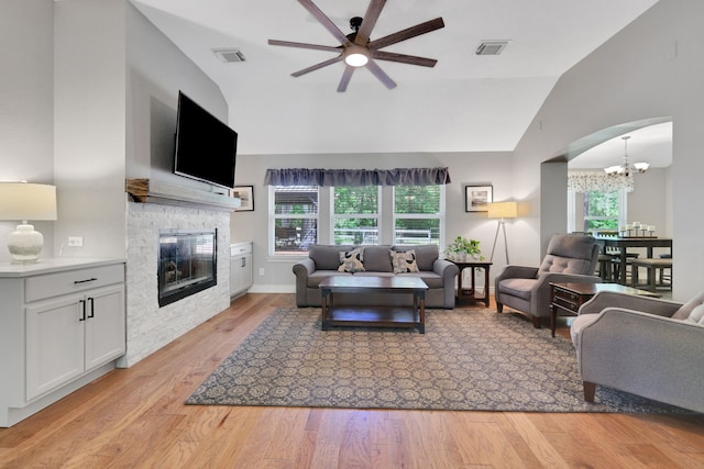 24240 Oak Hollow Blvd, Hockley, TX 77447 - living room featuring lofted ceiling, a ceiling fan, a fireplace, healthy amount of natural light, and a chandelier