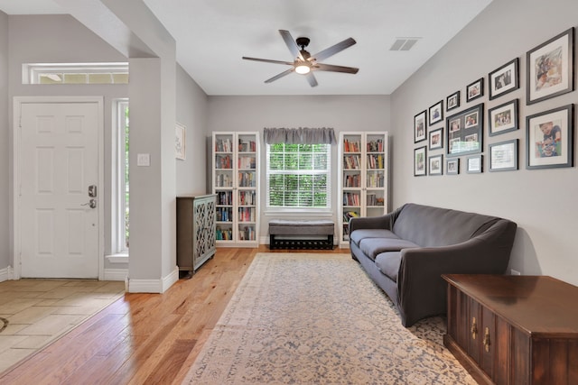 24240 Oak Hollow Blvd, Hockley, TX 77447 - living area featuring ceiling fan, light wood-style floors, and baseboards