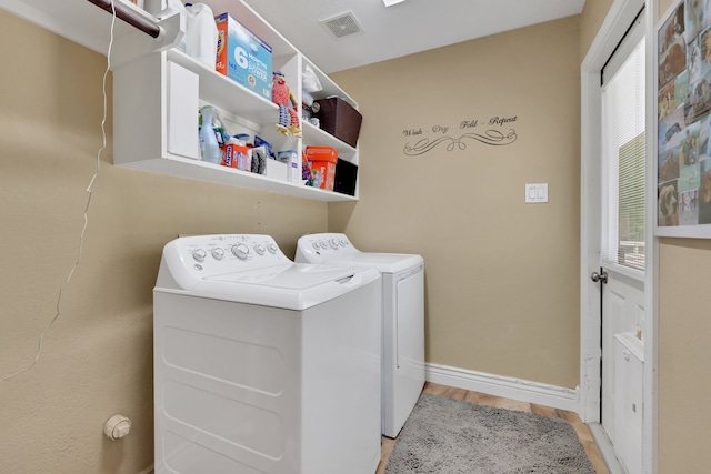 24240 Oak Hollow Blvd, Hockley, TX 77447 - laundry area featuring independent washer and dryer, wood finished floors, and baseboards