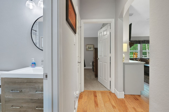 24240 Oak Hollow Blvd, Hockley, TX 77447 - corridor featuring light wood-style floors and a sink