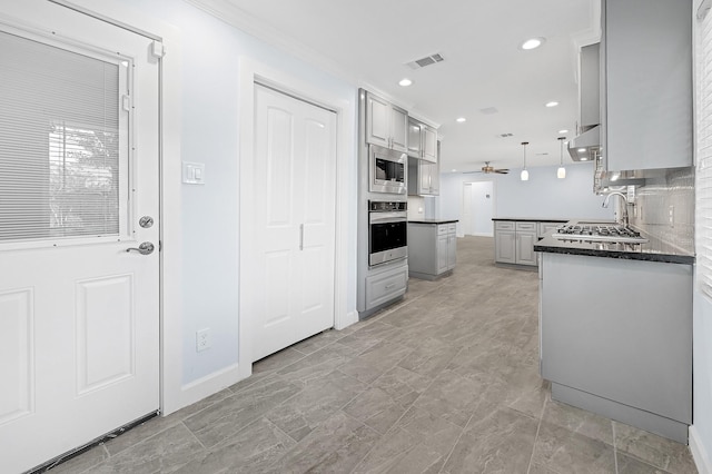 5623 Cerritos Dr, Houston, TX 77035 - kitchen featuring appliances with stainless steel finishes, ceiling fan, gray cabinets, recessed lighting, and under cabinet range hood