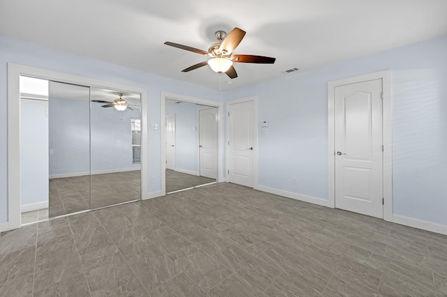 5623 Cerritos Dr, Houston, TX 77035 - unfurnished bedroom featuring two closets, baseboards, and ceiling fan