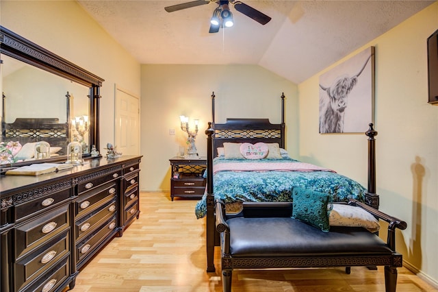 4406 Hidden Trace Ct, Houston, TX 77066 - bedroom with light wood finished floors, vaulted ceiling, ceiling fan, baseboards, and a textured ceiling
