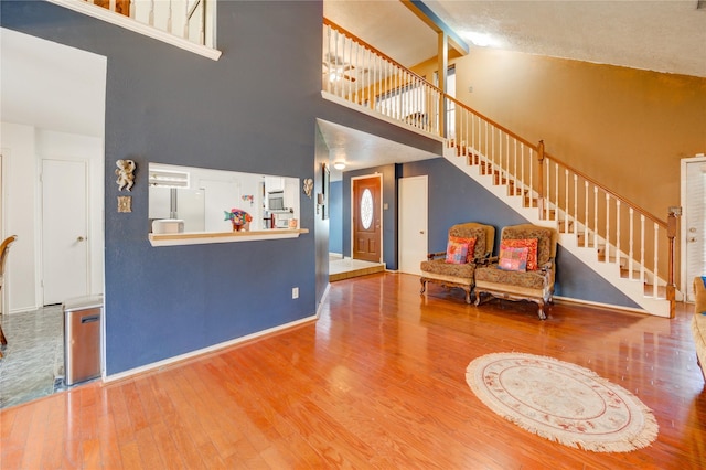 4406 Hidden Trace Ct, Houston, TX 77066 - living room with a high ceiling, wood finished floors, stairway, and baseboards