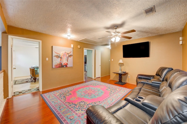 4406 Hidden Trace Ct, Houston, TX 77066 - living room featuring wood finished floors, ceiling fan, a textured ceiling, attic access, and baseboards