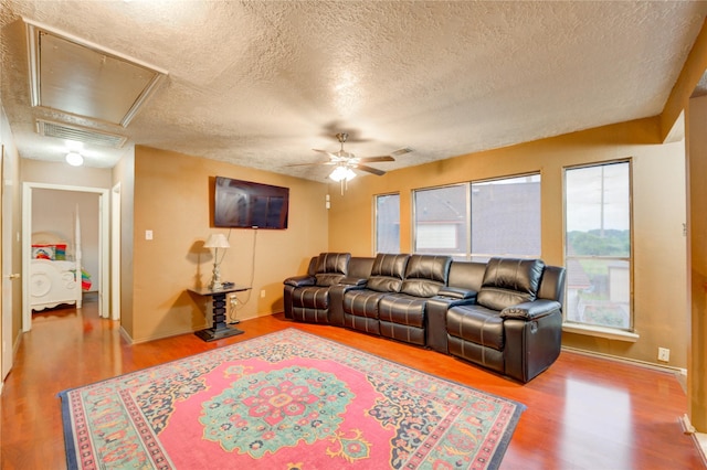 4406 Hidden Trace Ct, Houston, TX 77066 - living room featuring wood finished floors, ceiling fan, a textured ceiling, attic access, and baseboards