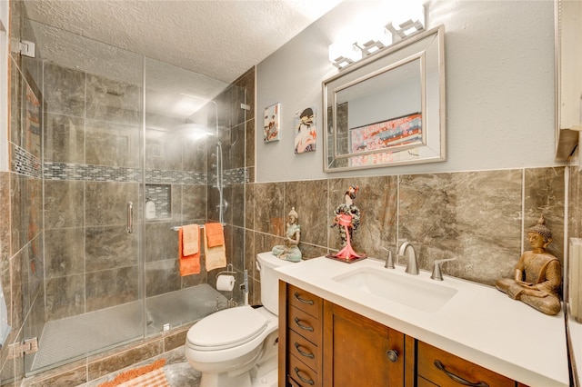 4406 Hidden Trace Ct, Houston, TX 77066 - bathroom featuring vanity, a shower stall, toilet, a textured ceiling, and tile walls