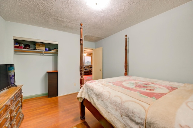 4406 Hidden Trace Ct, Houston, TX 77066 - bedroom with wood finished floors, a textured ceiling, and a closet