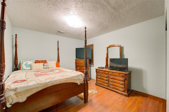 4406 Hidden Trace Ct, Houston, TX 77066 - bedroom featuring light wood-style floors and a textured ceiling